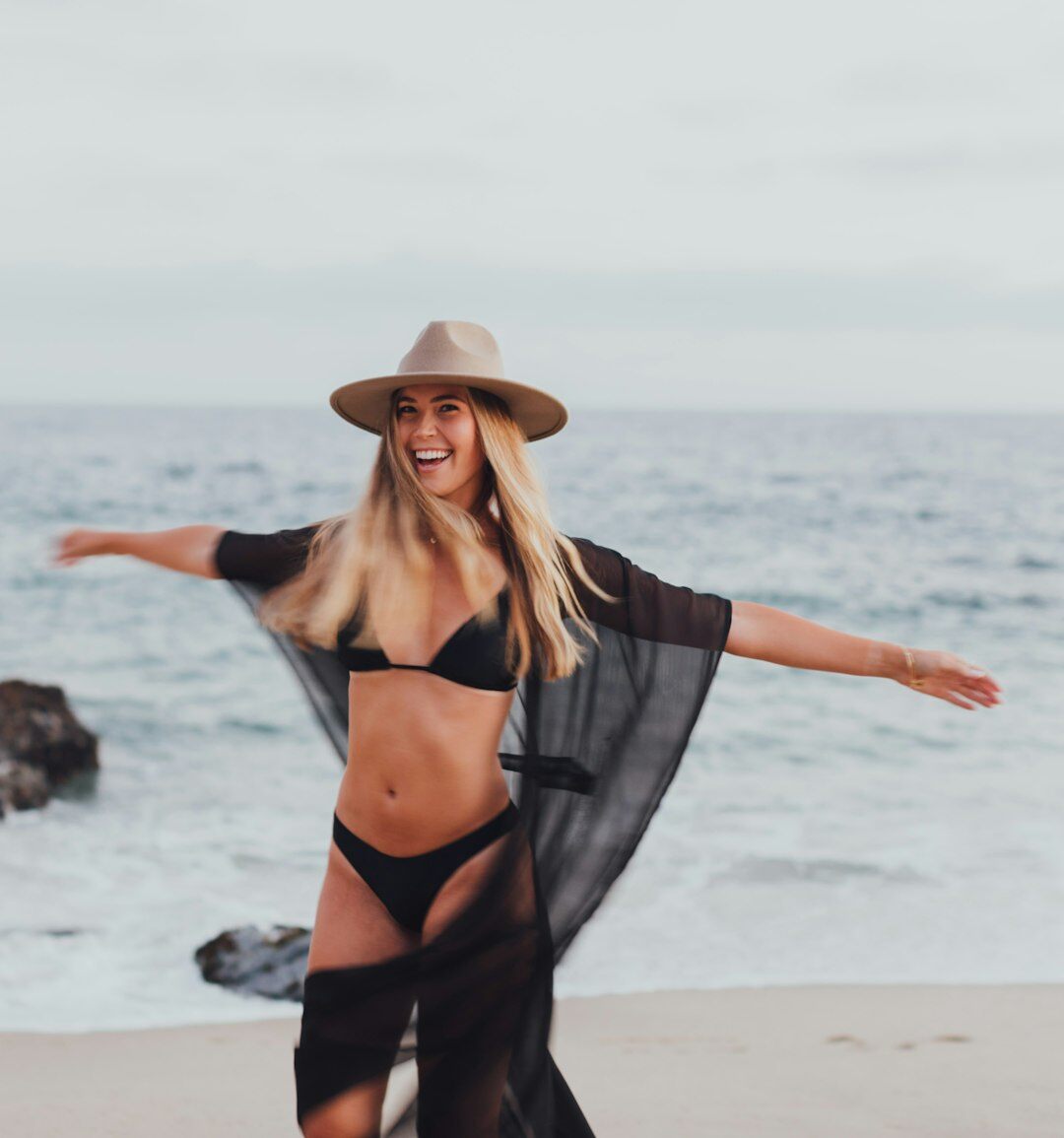 Young Uruguayan influencer with sunglasses at a beach party